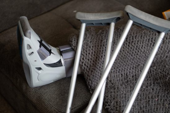 pair of crutches resting against injured foot