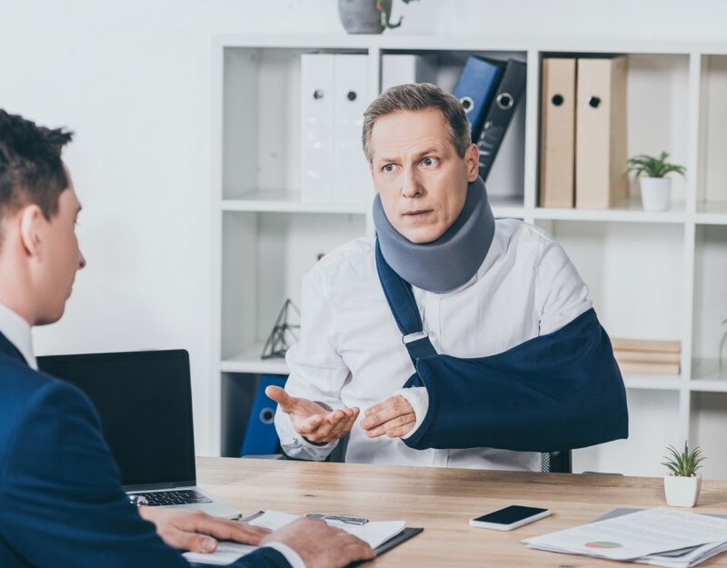 Man talking to a lawyer, Navigating Personal Injury Compensation Claims After Car Accidents in Queensland