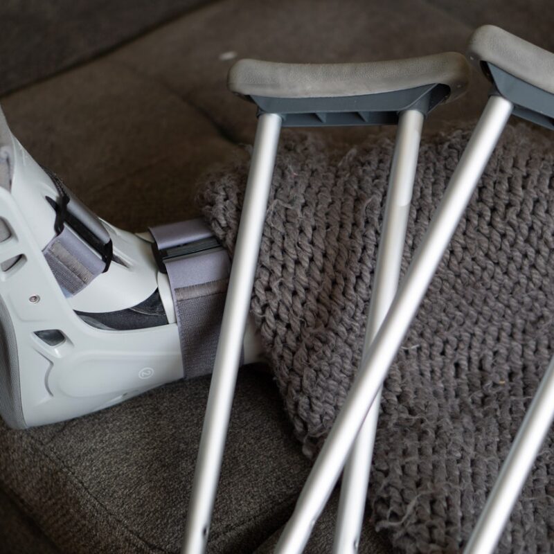 pair of crutches resting against injured foot